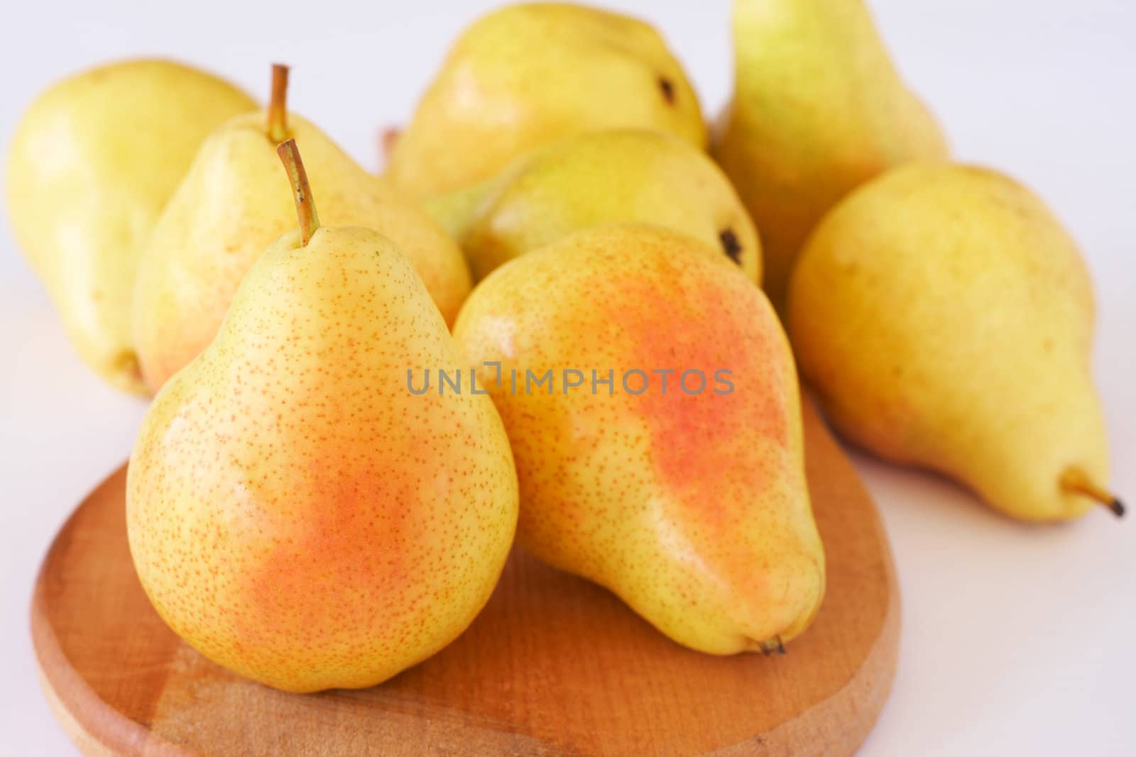 Ripe yellow pears on white background