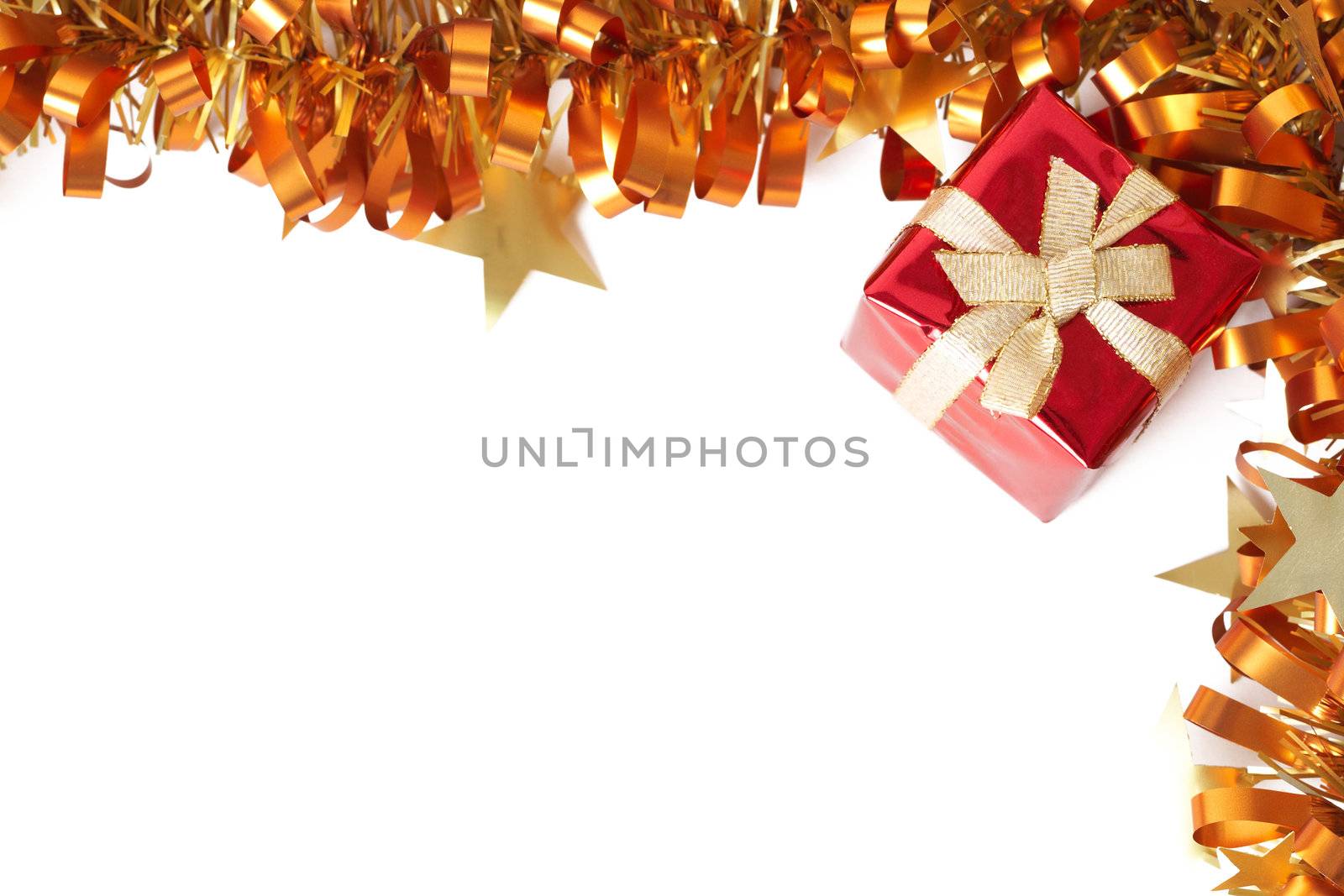 Red Christmas gift with golden tinsel frame isolated on white background with copy space. 