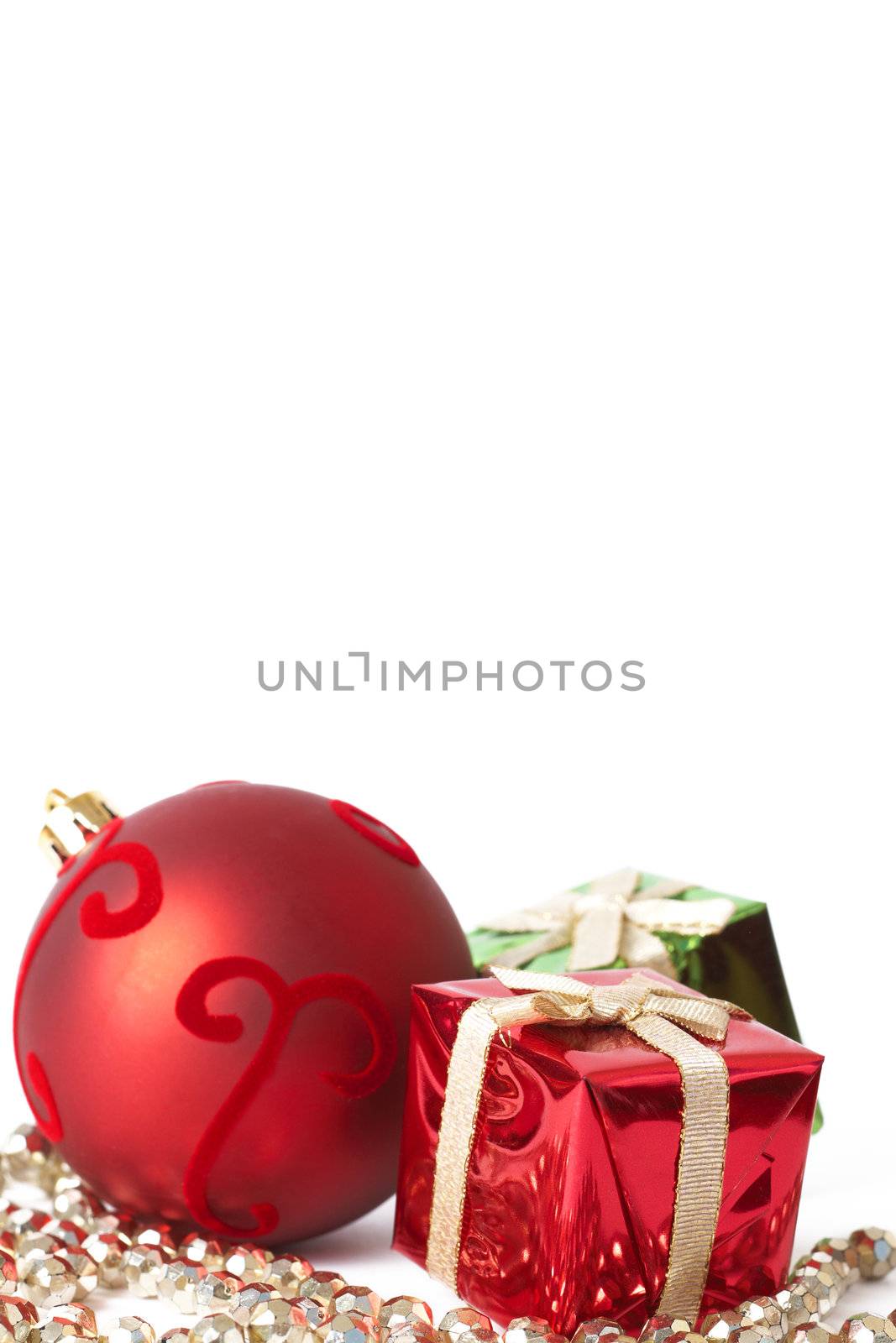 Red Christmas bauble and two gift boxes isolated on white background with copy space. 