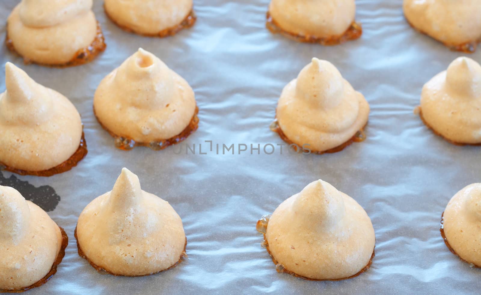 Freshly baked meringue cookies on a baking tray