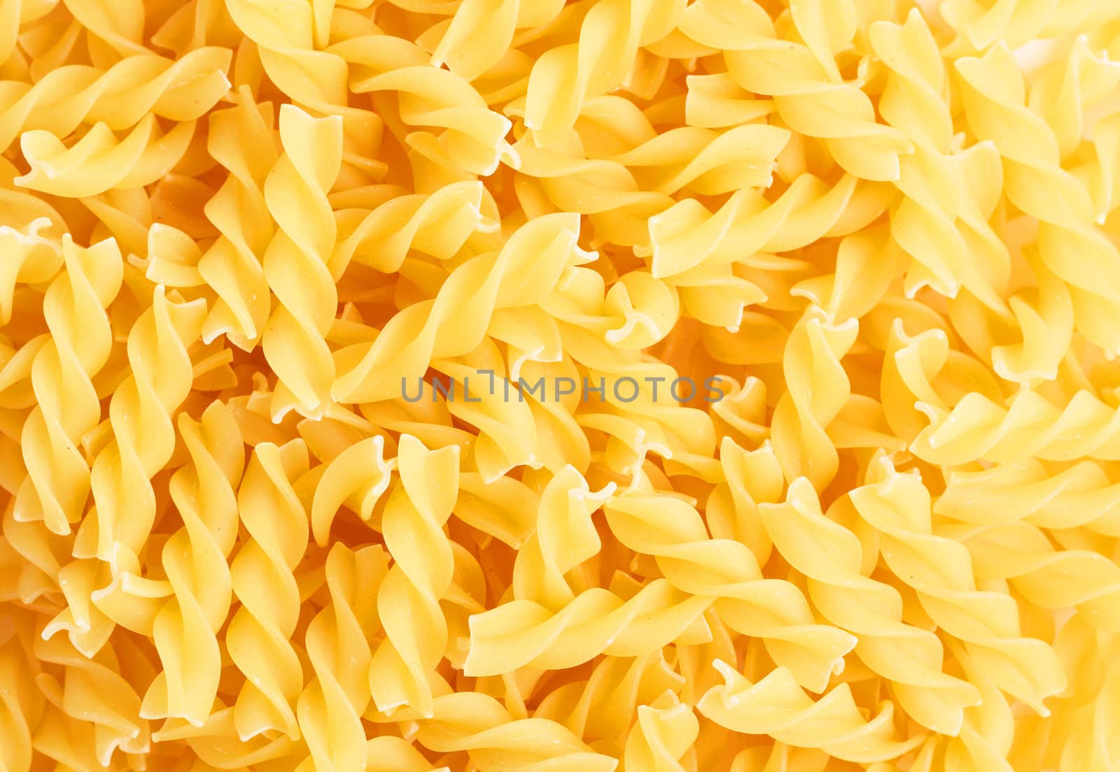 Closeup of Fusilli swirl pasta forming a background