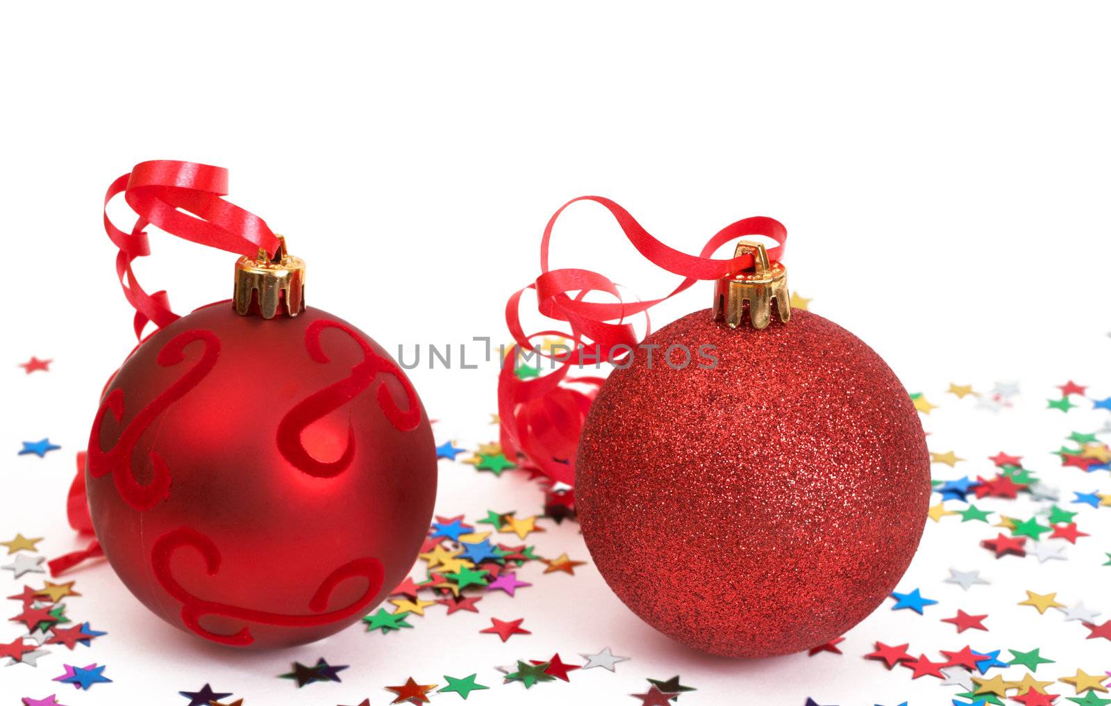 Two red Christmas baubles with stars isolated on white background with copy space. 