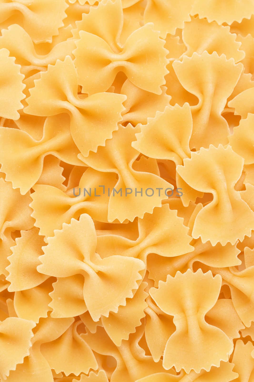Closeup of Bow tie pasta Farfalloni forming a background