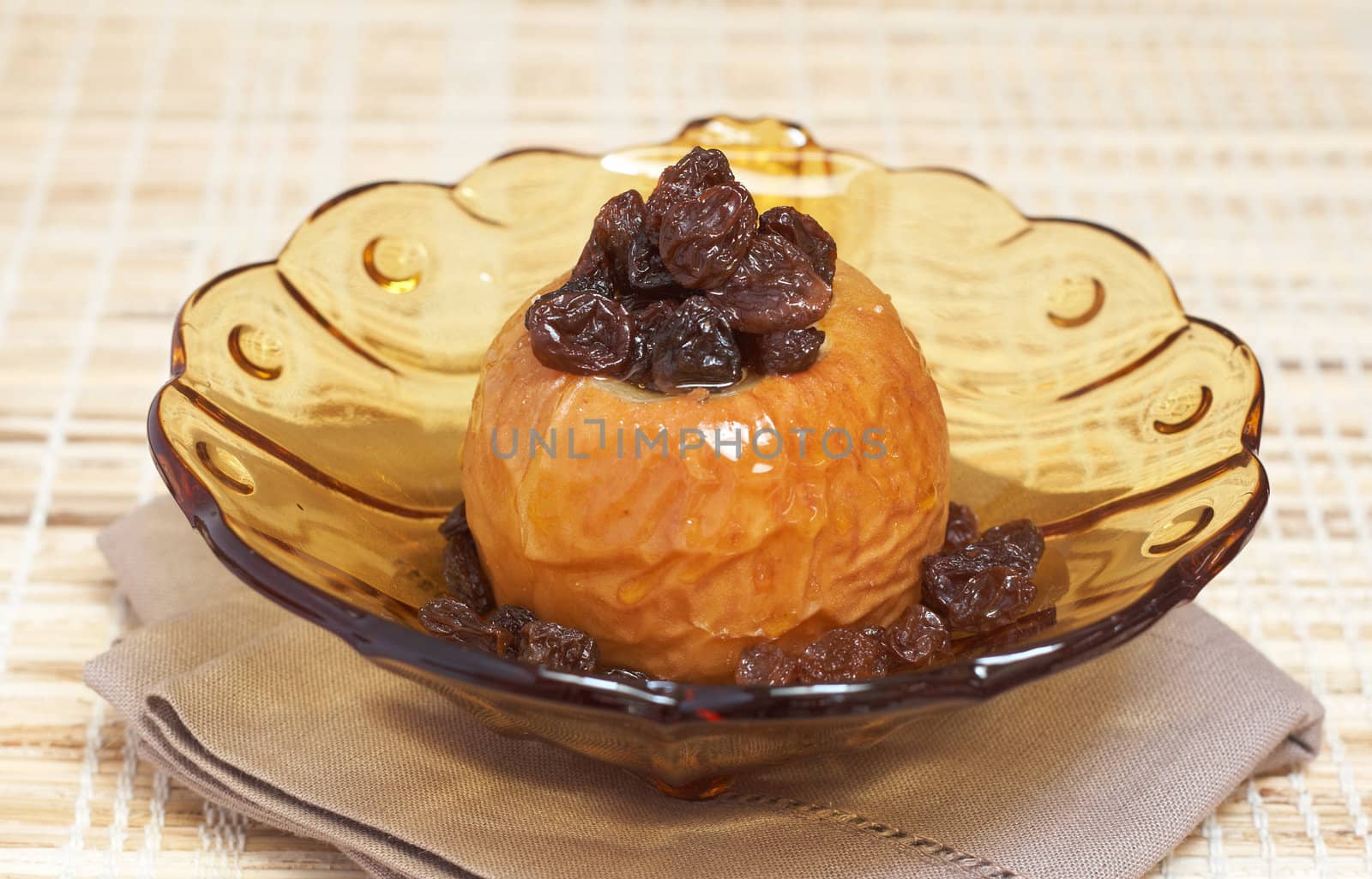 Delicious dessert of freshly baked organic apple with raisins