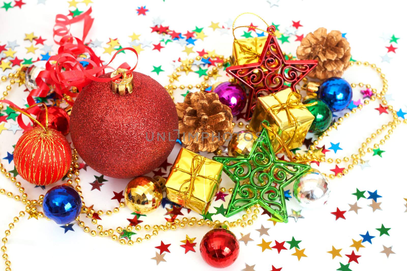 Red Christmas baubles and other decorations with stars on white background with copy space