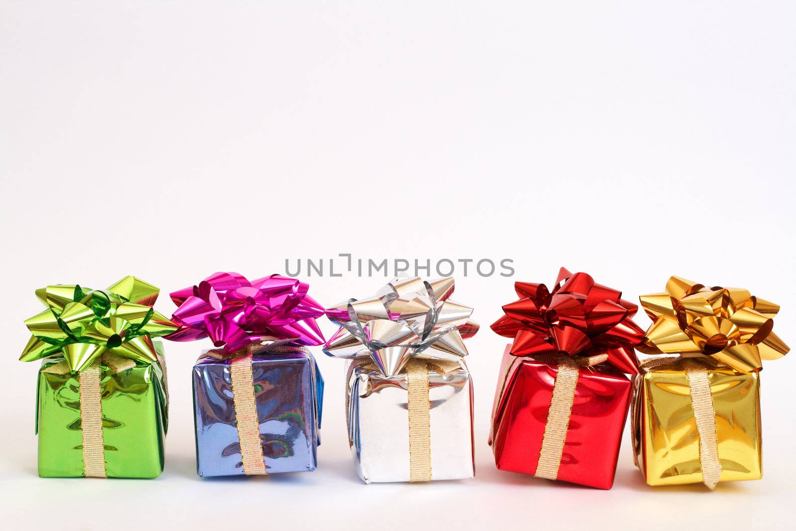 Colorful gift boxes with a bows for Christmas or Valentines Day isolated on white background with copy space