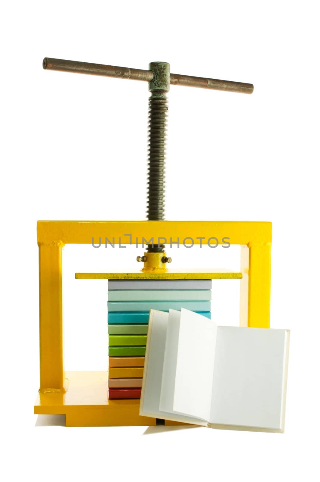 Pile of colorful books under the press and an open book isolated on white