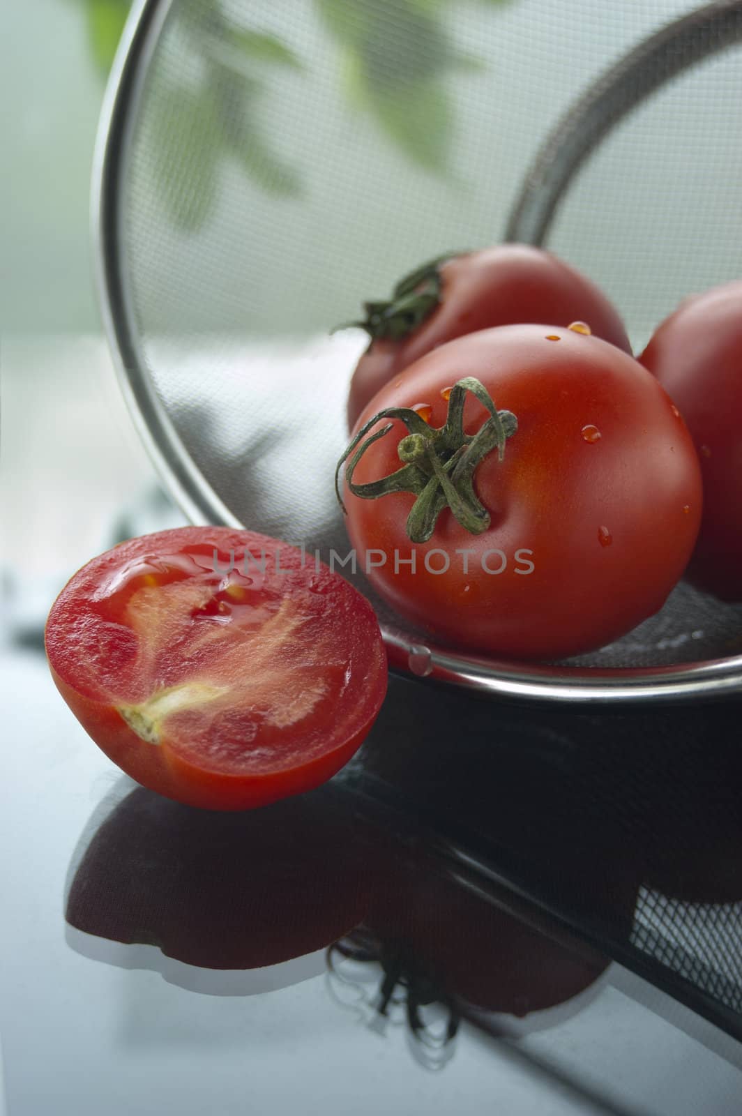tomatoes in strainer, leaves