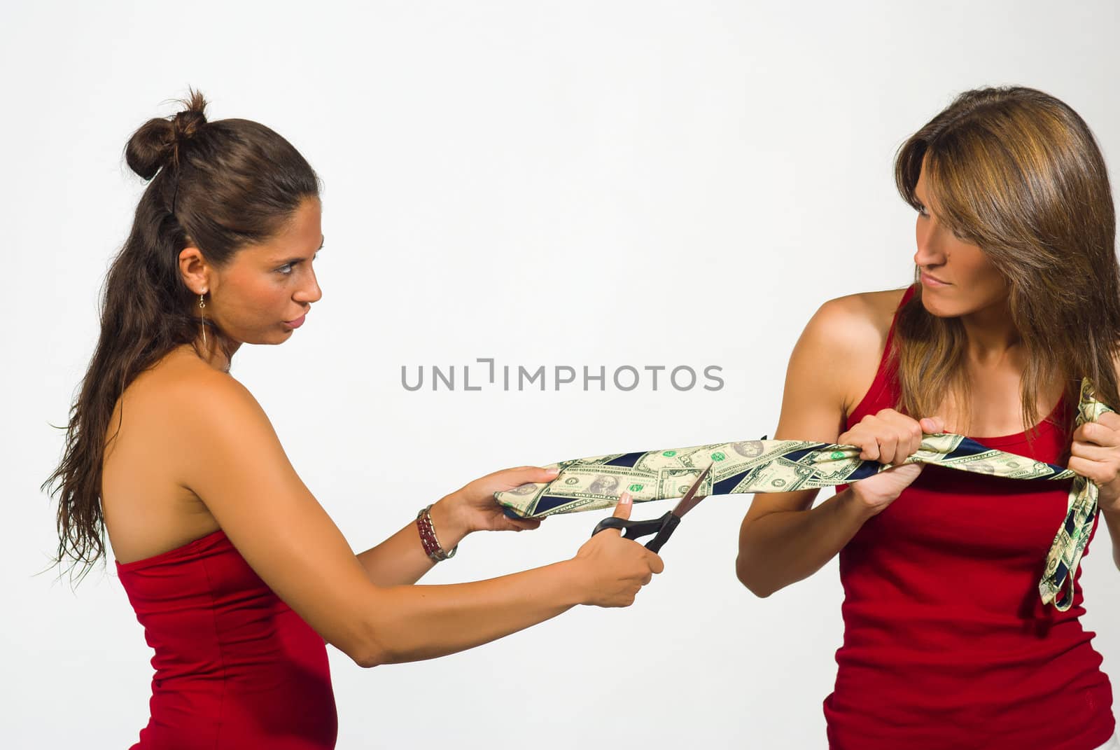 Two women  pulling a tie with dollar notes