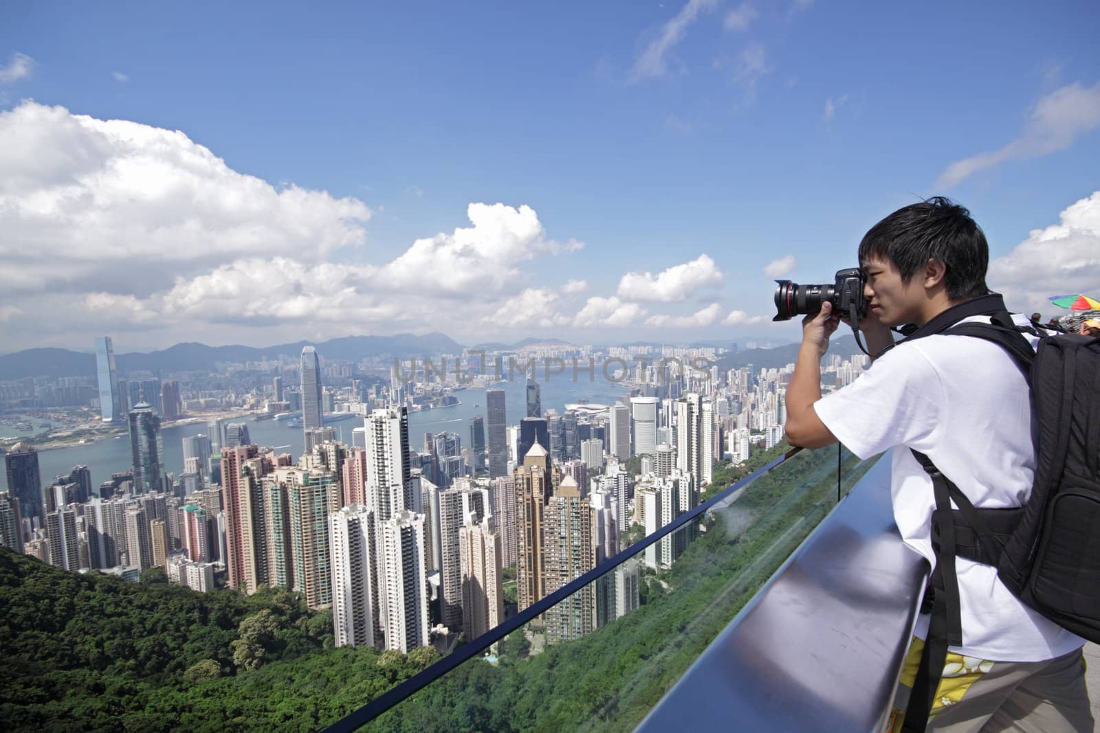 Tourist taking photo of Hong Kong skyline by his digital camera 