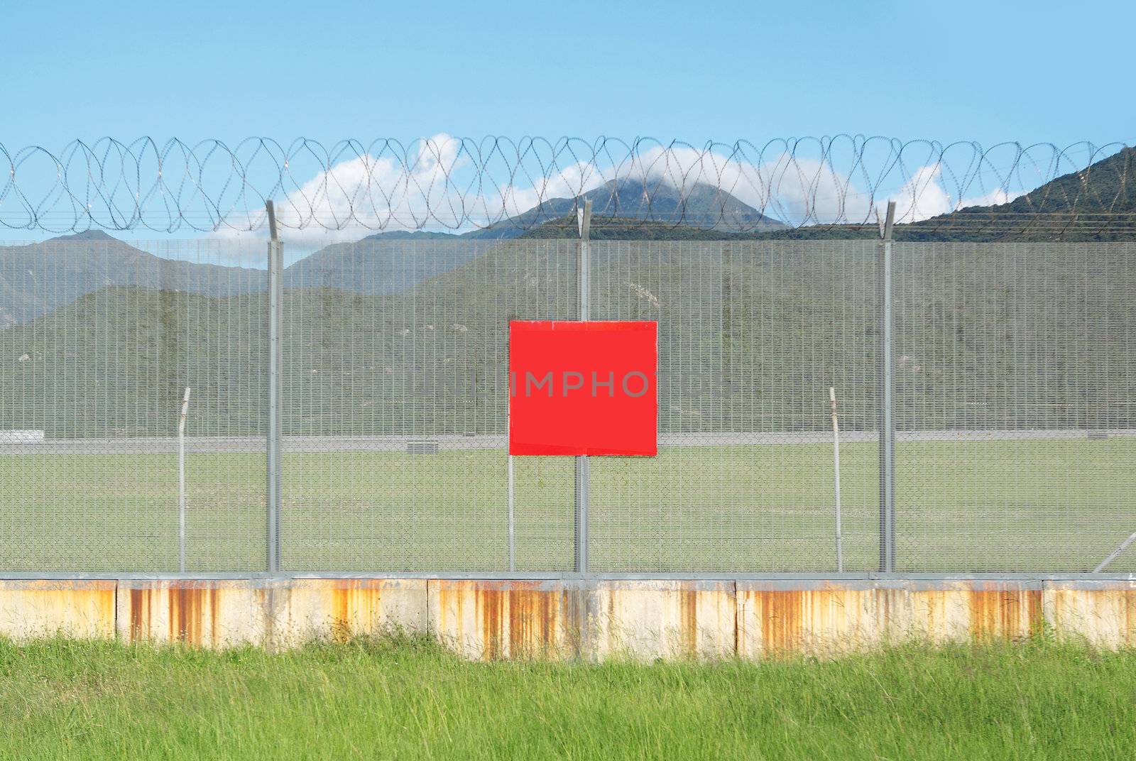 metal fence in the nature and red board for text