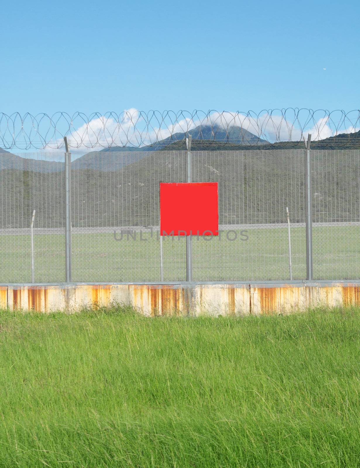 metal fence in the nature and red board for text