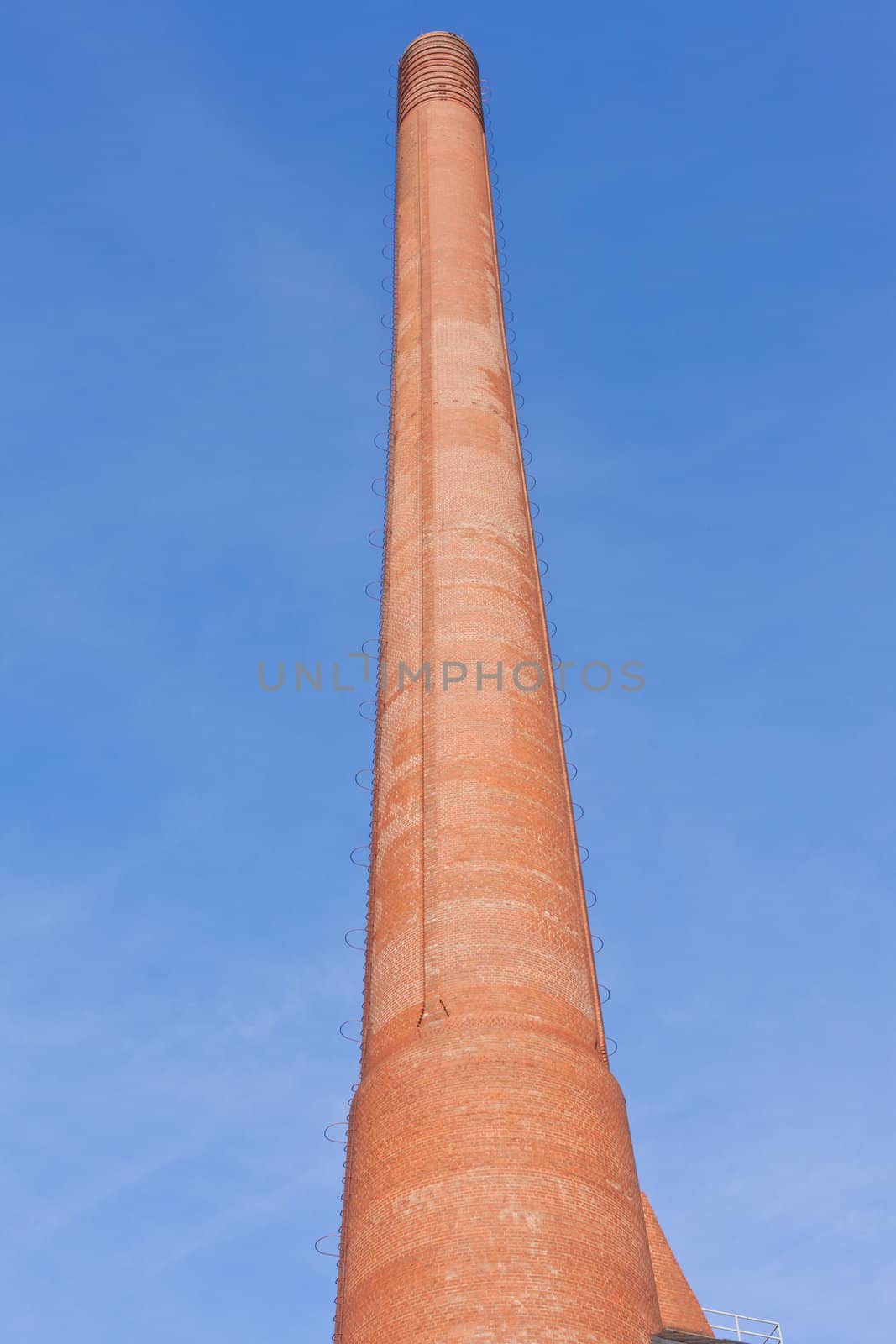 Retro designed industrial brick building with high red brick chimney.