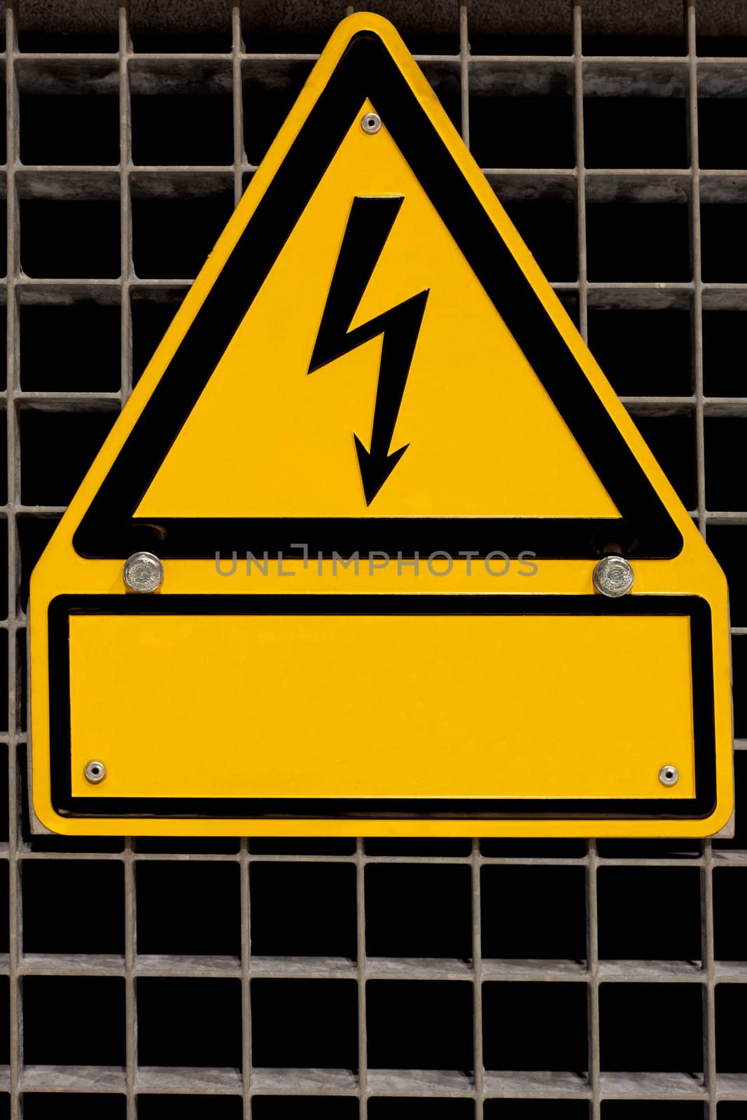 Metal high voltage danger sign bolted to steel grid with blank copyspace for your message.