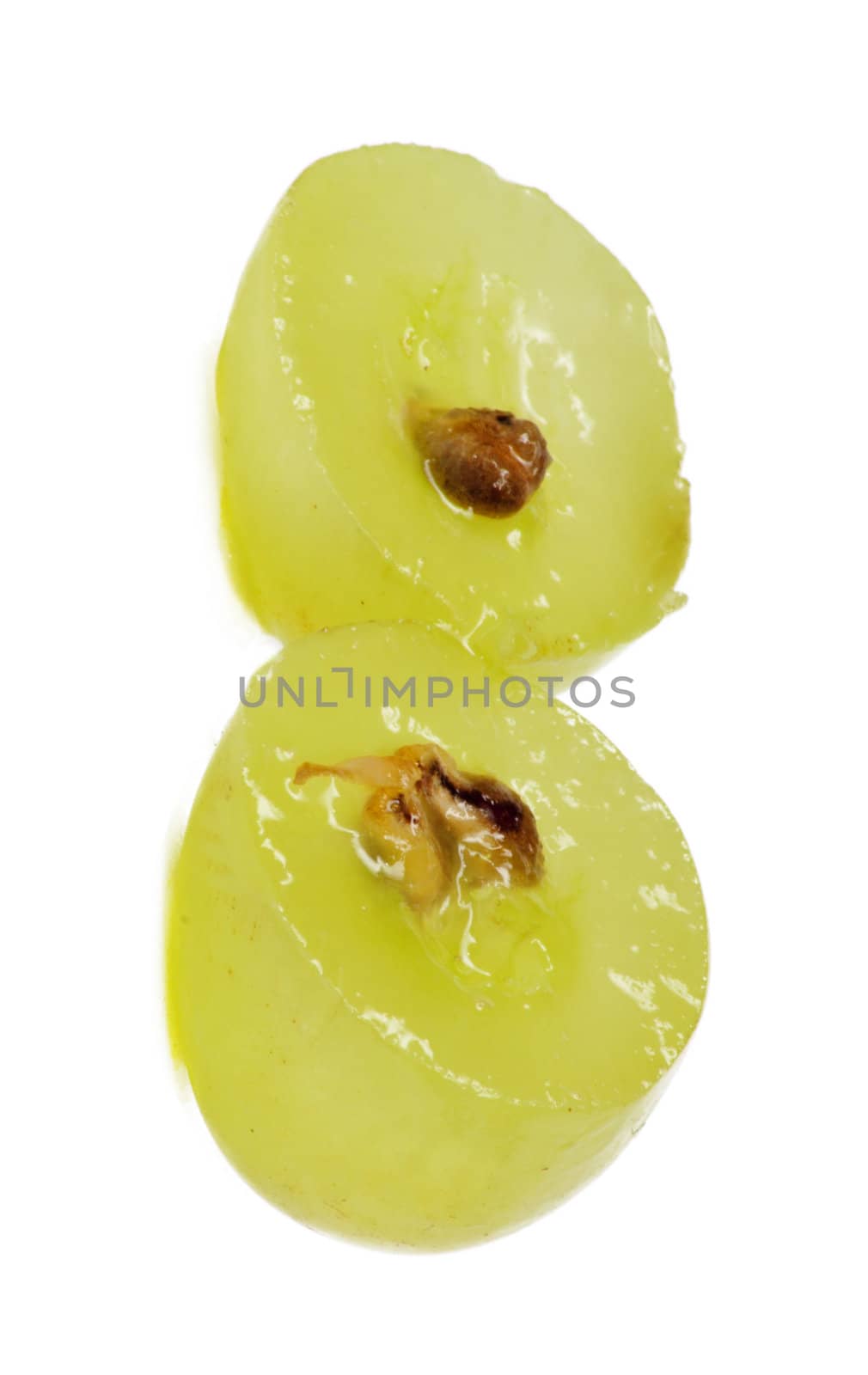 Translucent slice of green grape fruit, macro isolated on white 