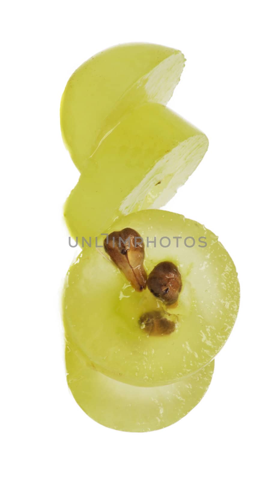 Translucent slice of green grape fruit, macro isolated on white 