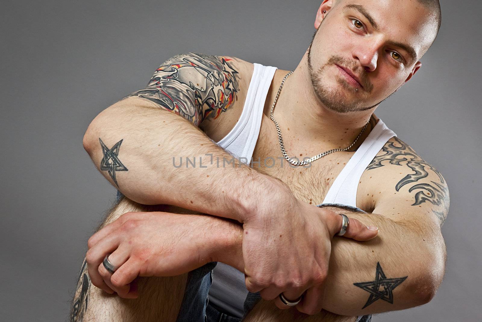 An image of a handsome man with tattoos