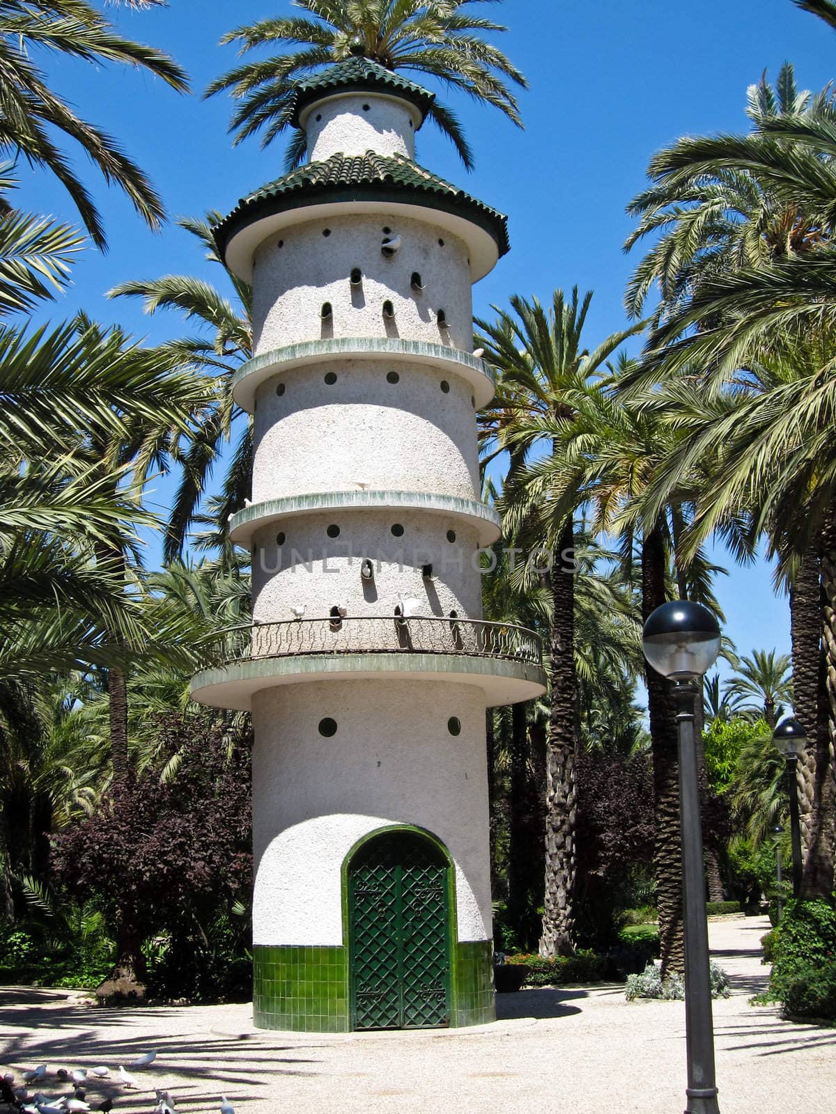 Dovecote tower with doves in a park in Elche, Spain