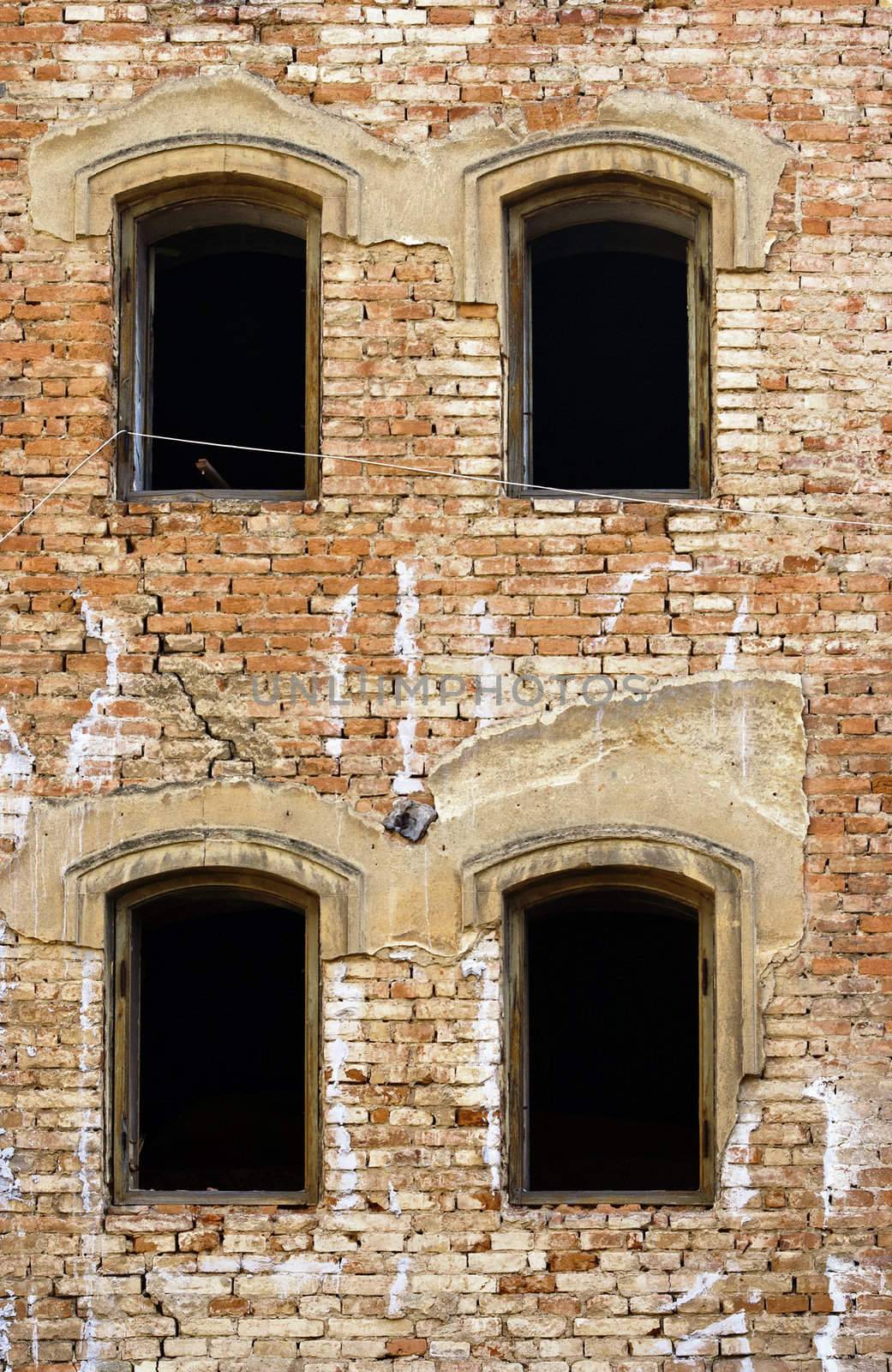 Detail of the broken windows and old house