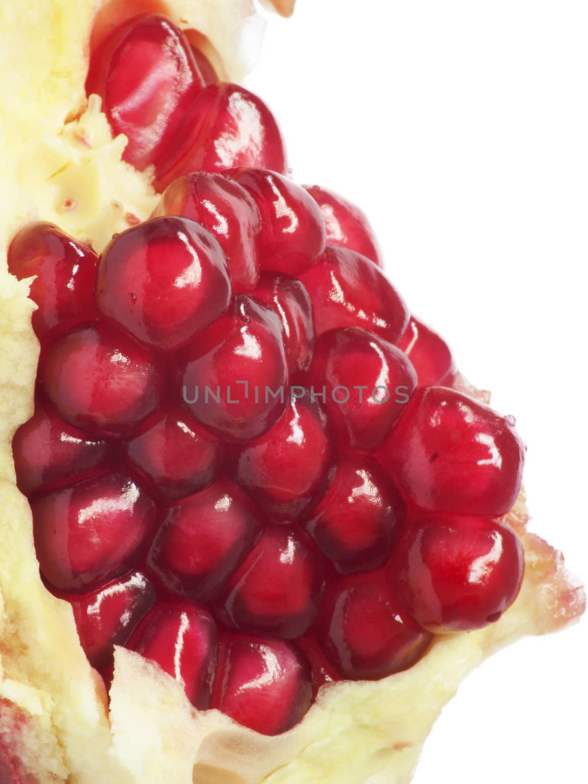 Extreme close up background of a red juicy ripe pomegranate fruit seeds 