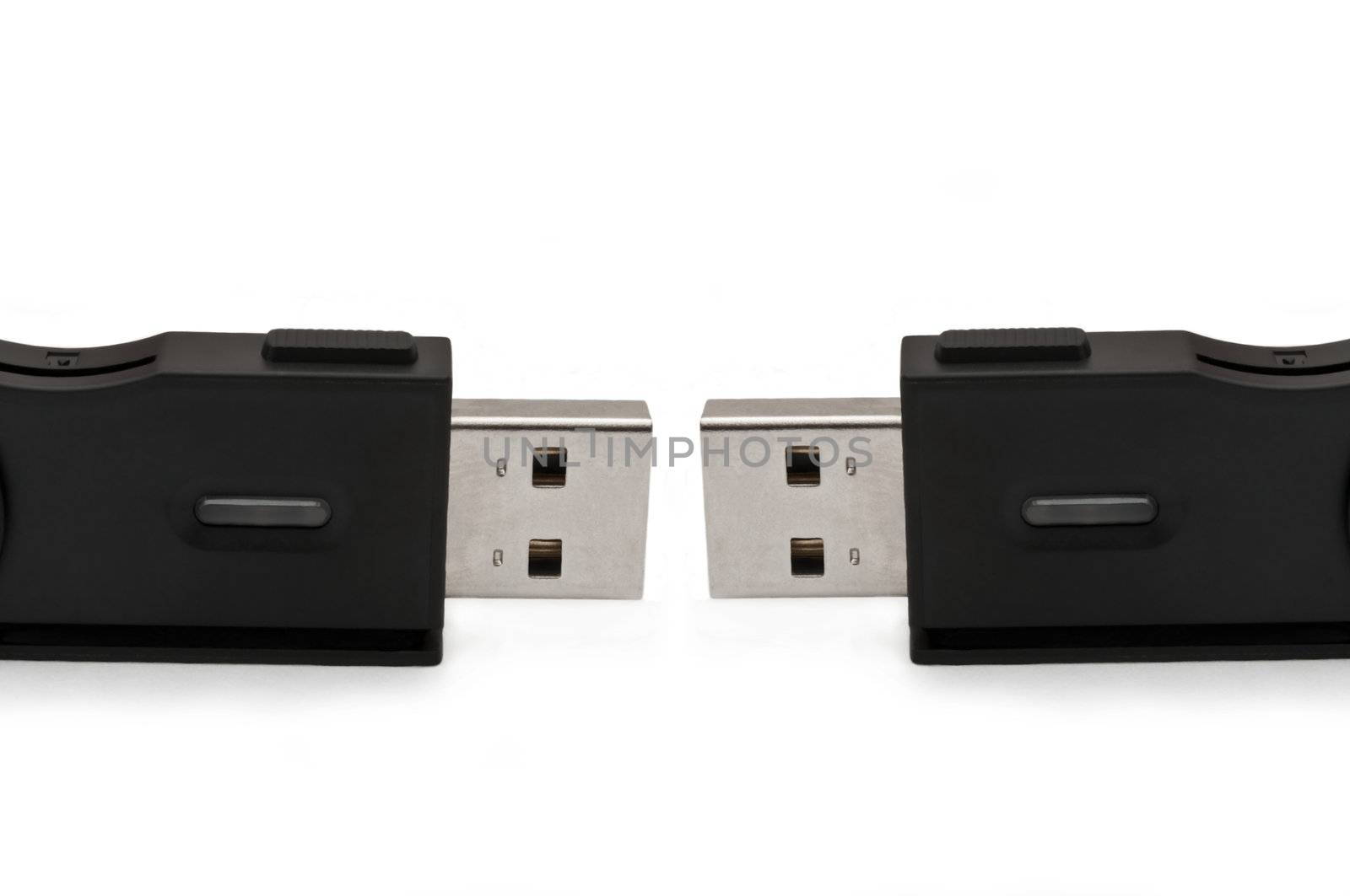 Close and low level capturing two usb sd adaptors arranged over white