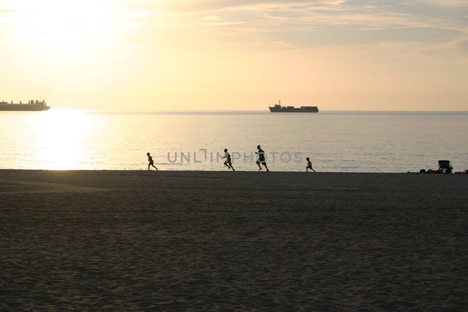 Family running together on a beach