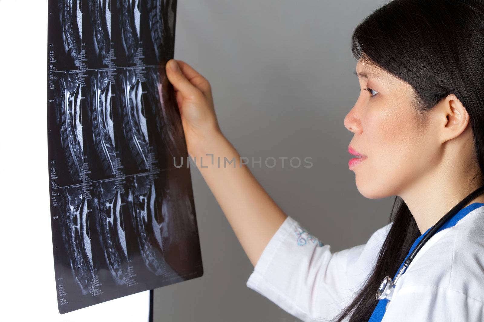 Attractive female Asian Doctor Viewing MRI
