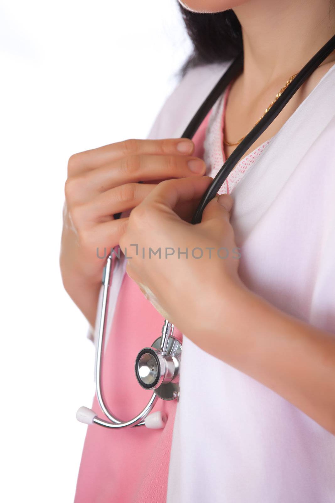Female healthcare worker holding stethoscope hung around neck.