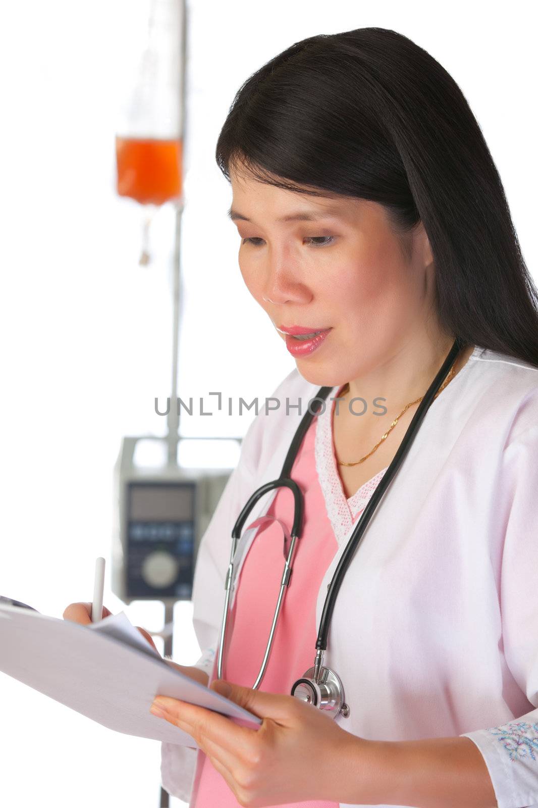 Attractive Asian female nurse in clinic environment with chart. IV Pump and blood in background.