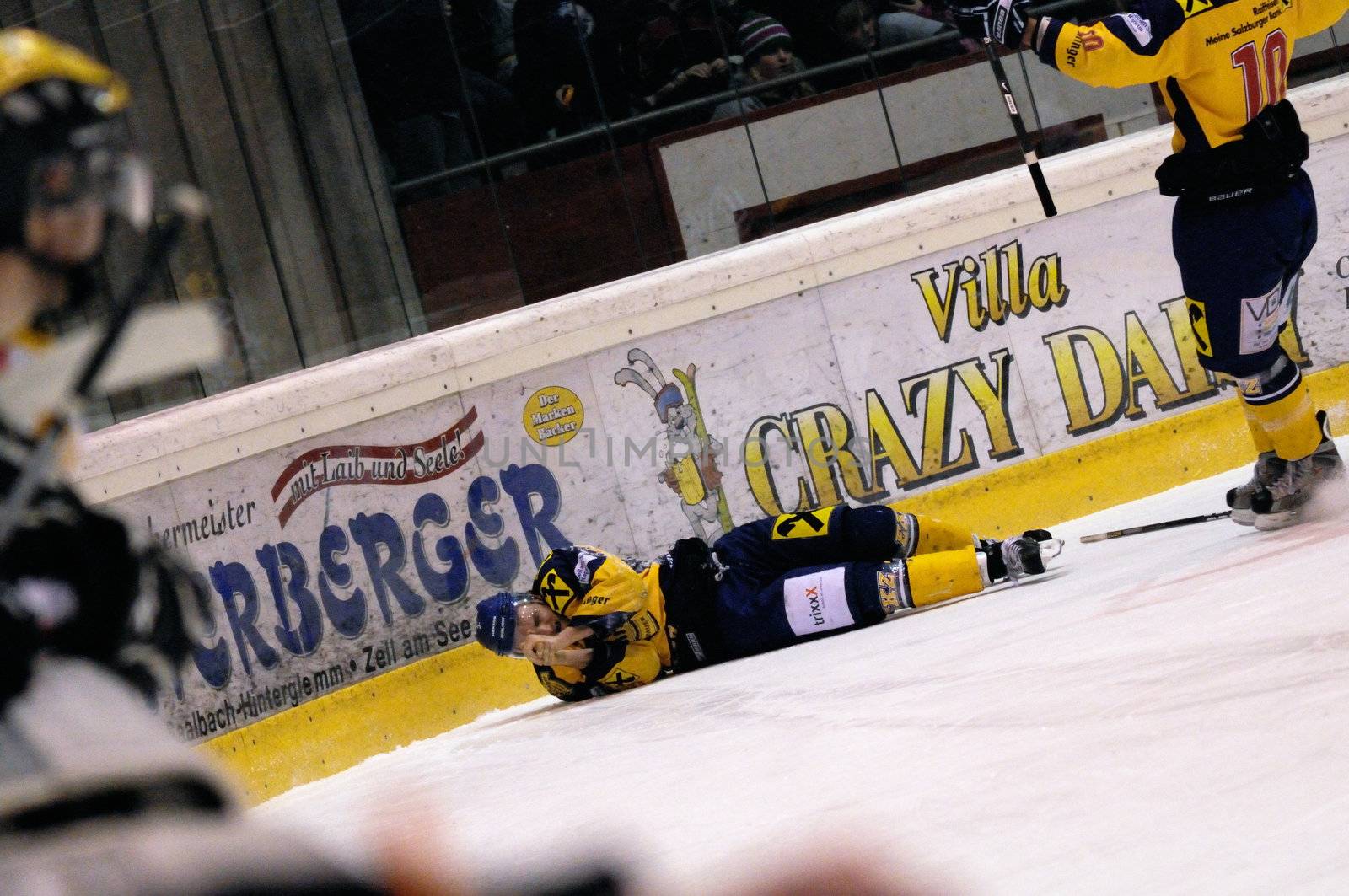 ZELL AM SEE, AUSTRIA - FEB 22: Austrian National League. Stefan Uhl injured after a cheap shot by Remi Royer. Game EK Zell am See vs. VEU Feldkirch (Result 3-1) on February 22, 2011 at hockey rink of Zell am See