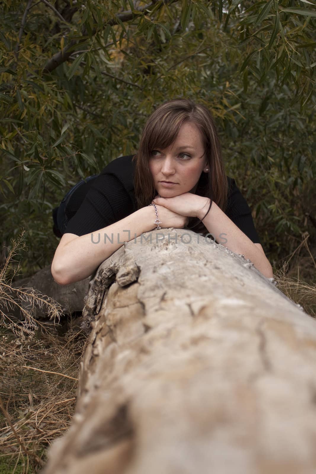 young model posing on a log.