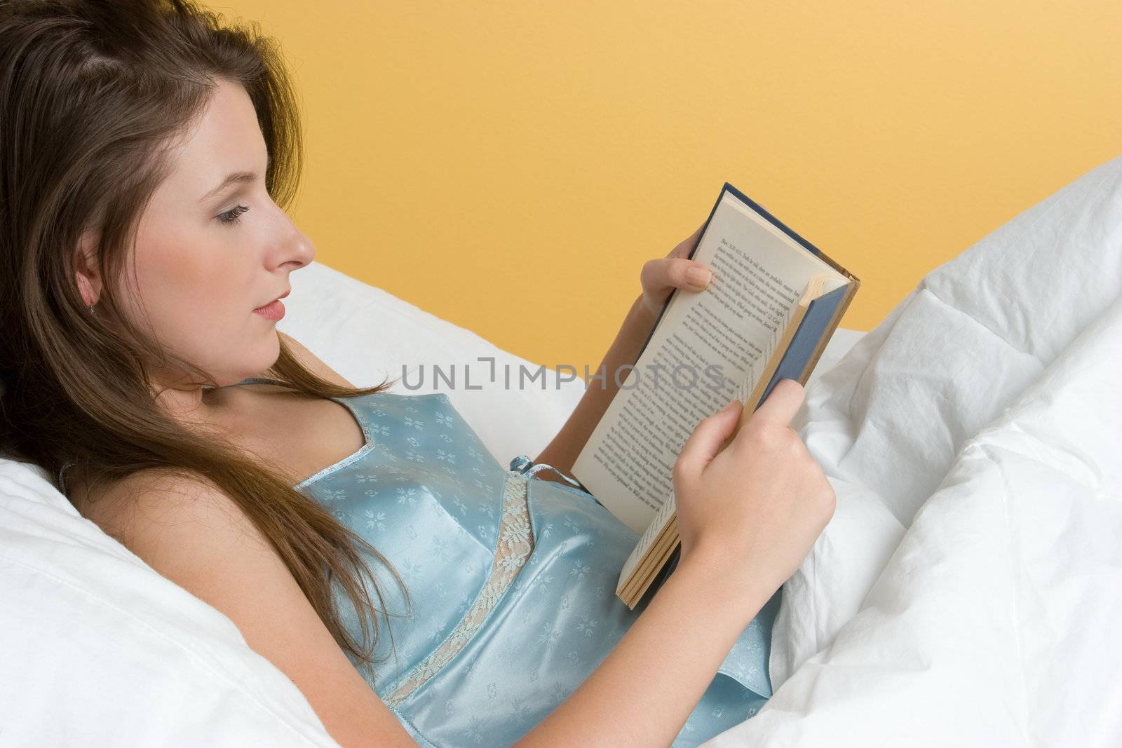 Beautiful woman reading in bed