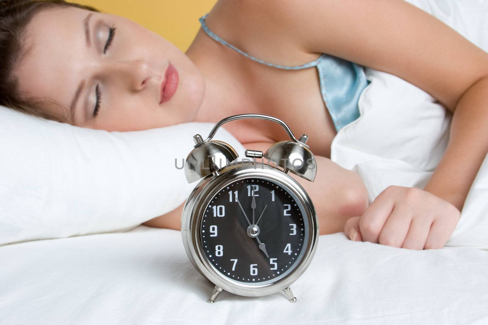 Woman sleeping alarm clock bed