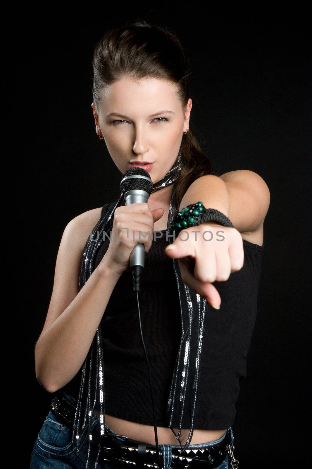 Beautiful singing woman holding microphone