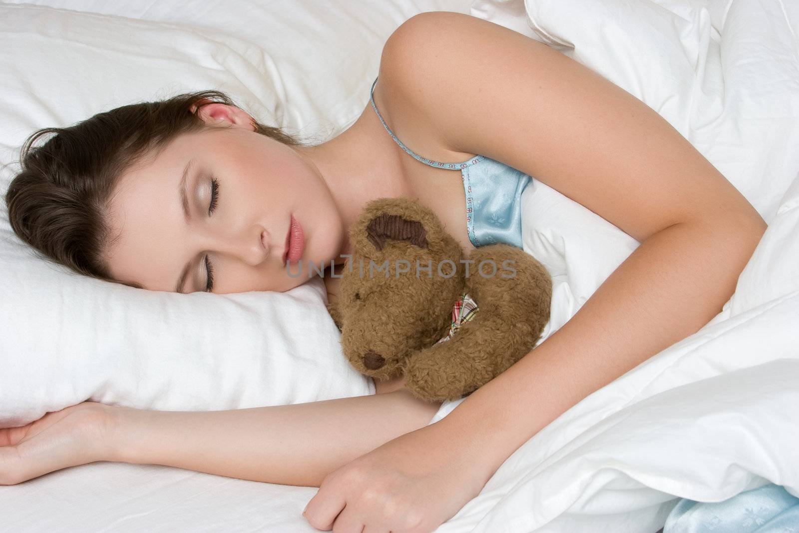 Woman sleeping with teddy bear