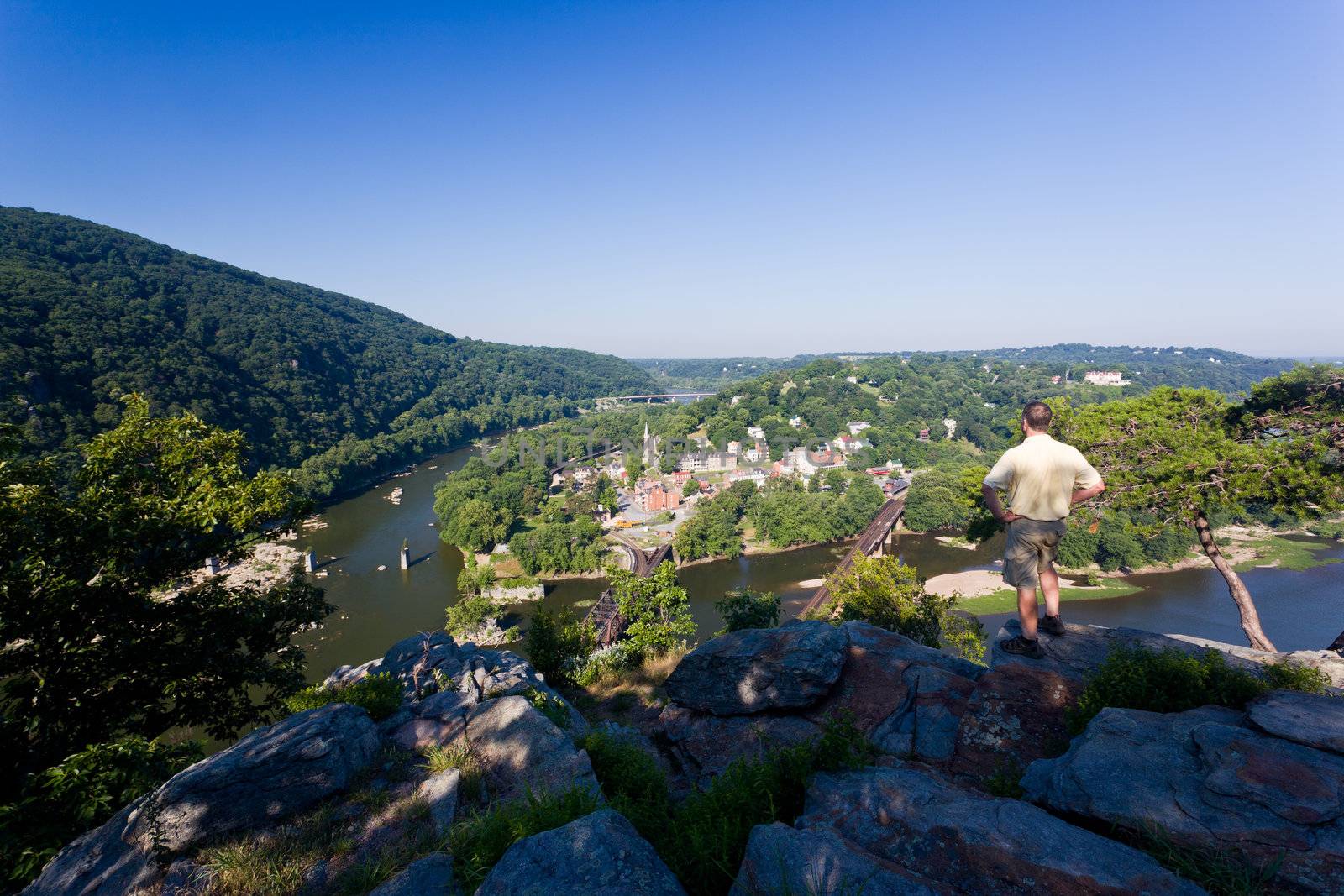 Senior male hiker overlooking the shenandoah and potomac rivers by the town of Harpers Ferry