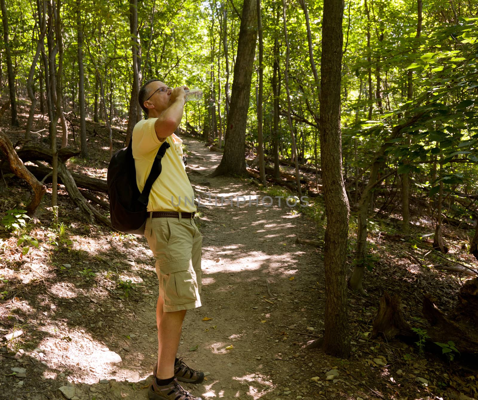 Senior man hiking in forest with backpack by steheap