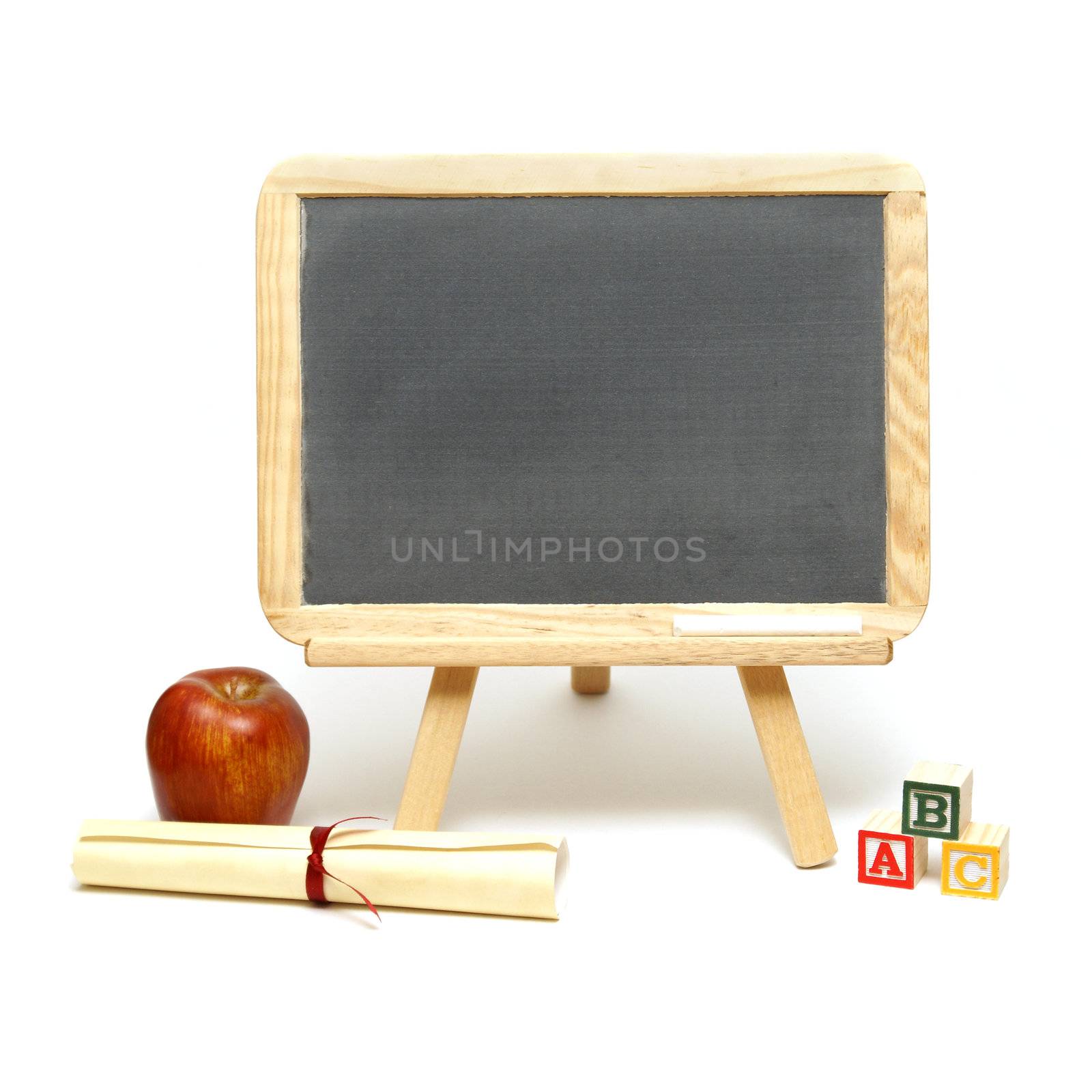 A blank chalkboard with other school items for displaying your message.