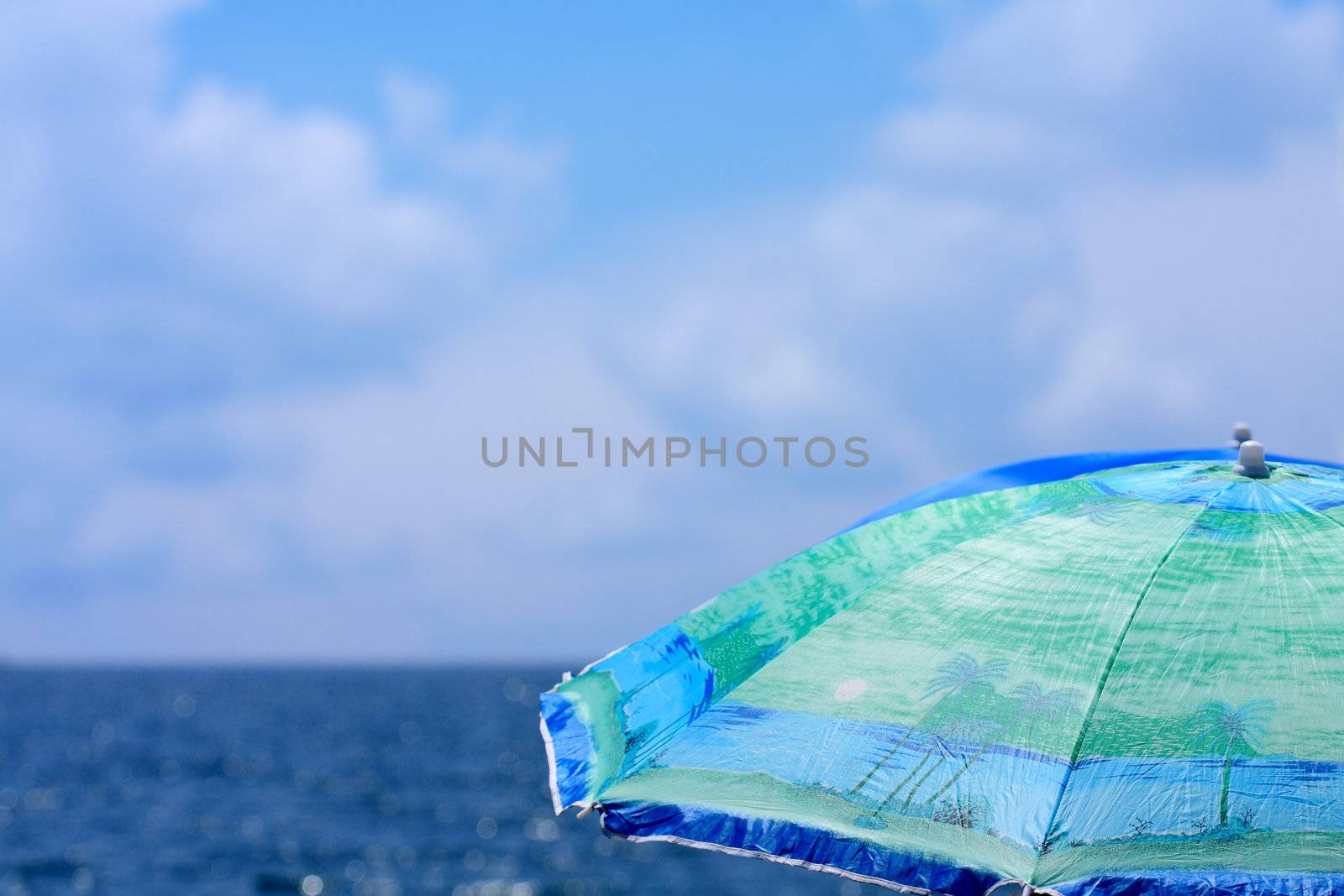 Beach umbrella close up against a sea landscape