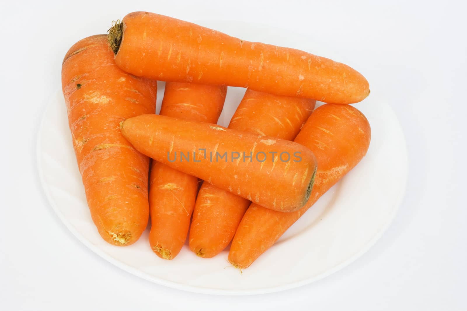 Ripe fresh carrots on a white background. 