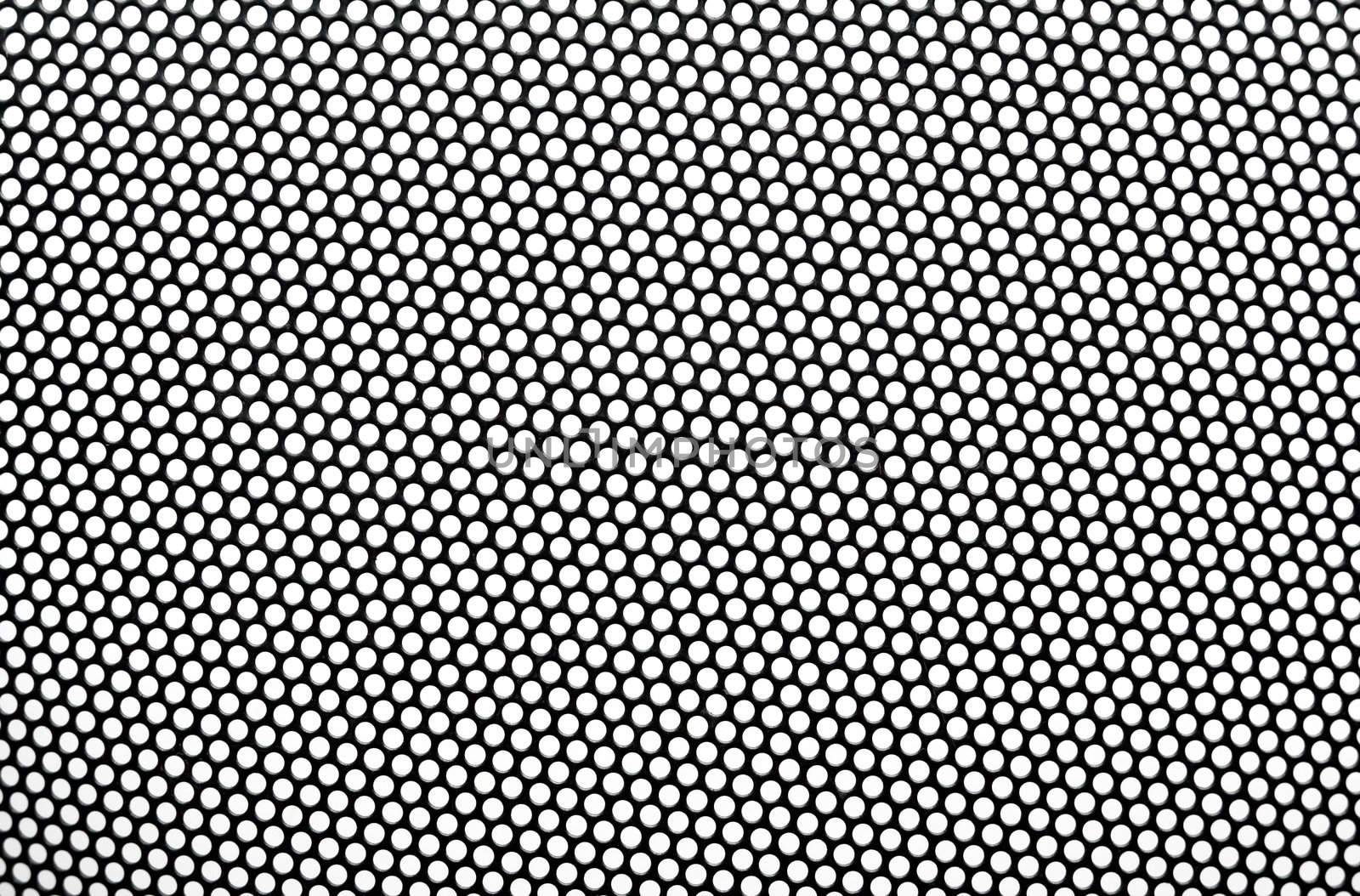 Black metal lattice with round apertures on white background. Close-up.