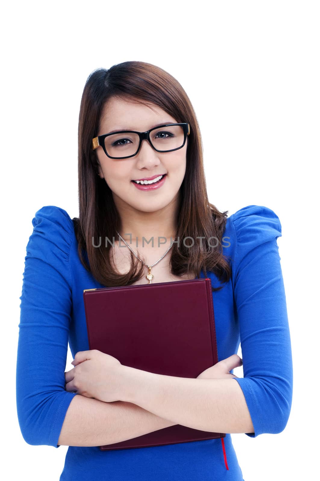 Portrait of a cute female student in eyeglasses hugging her book tightly over white background.