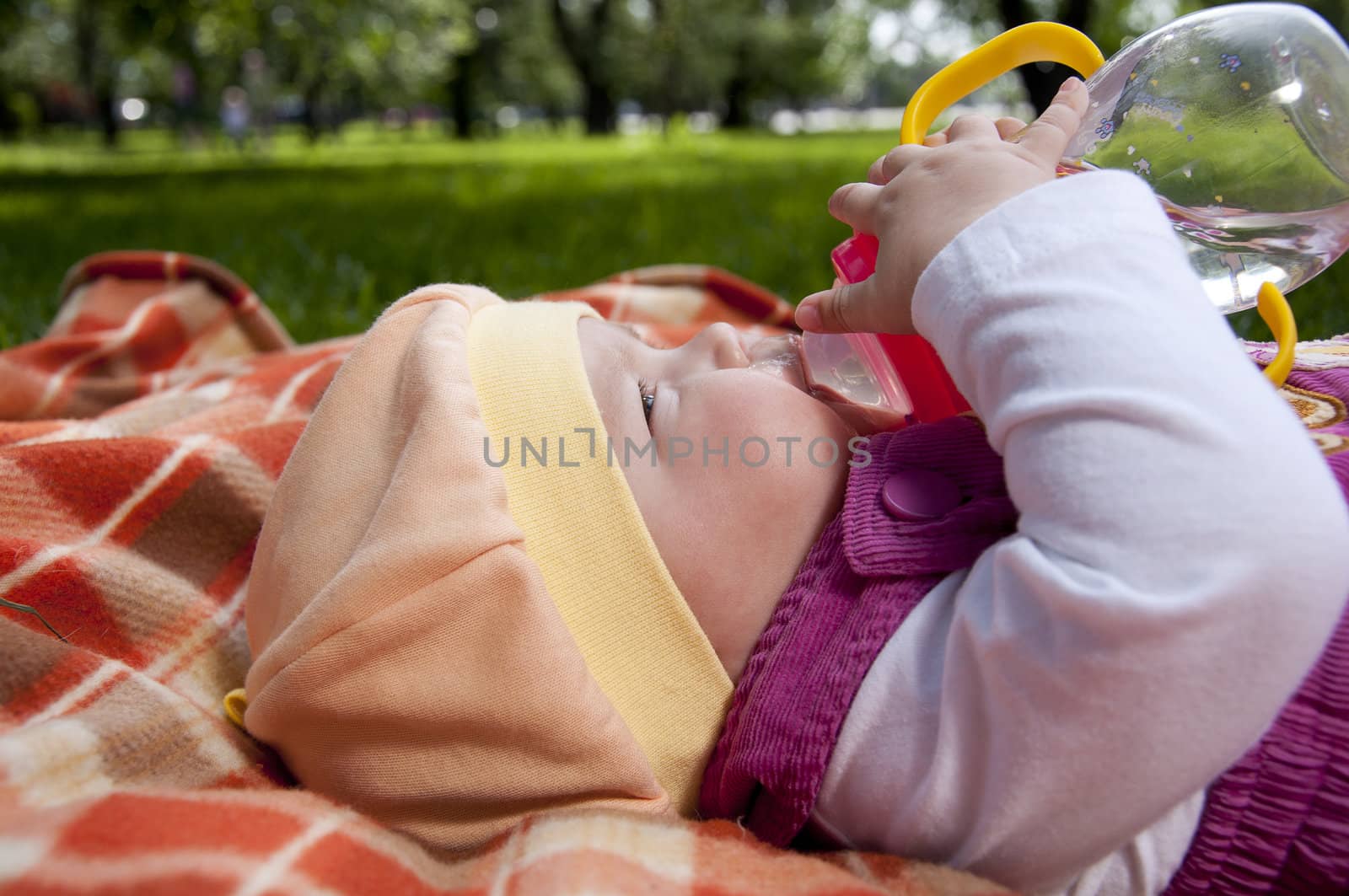 Portrait of the baby, on coverlet in the park by adam121
