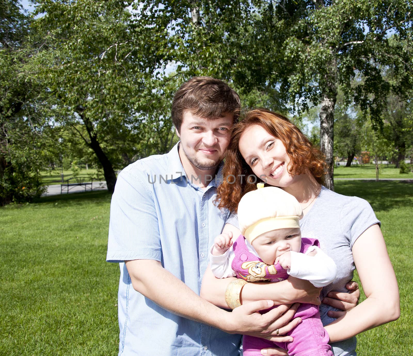 Young family in park by adam121