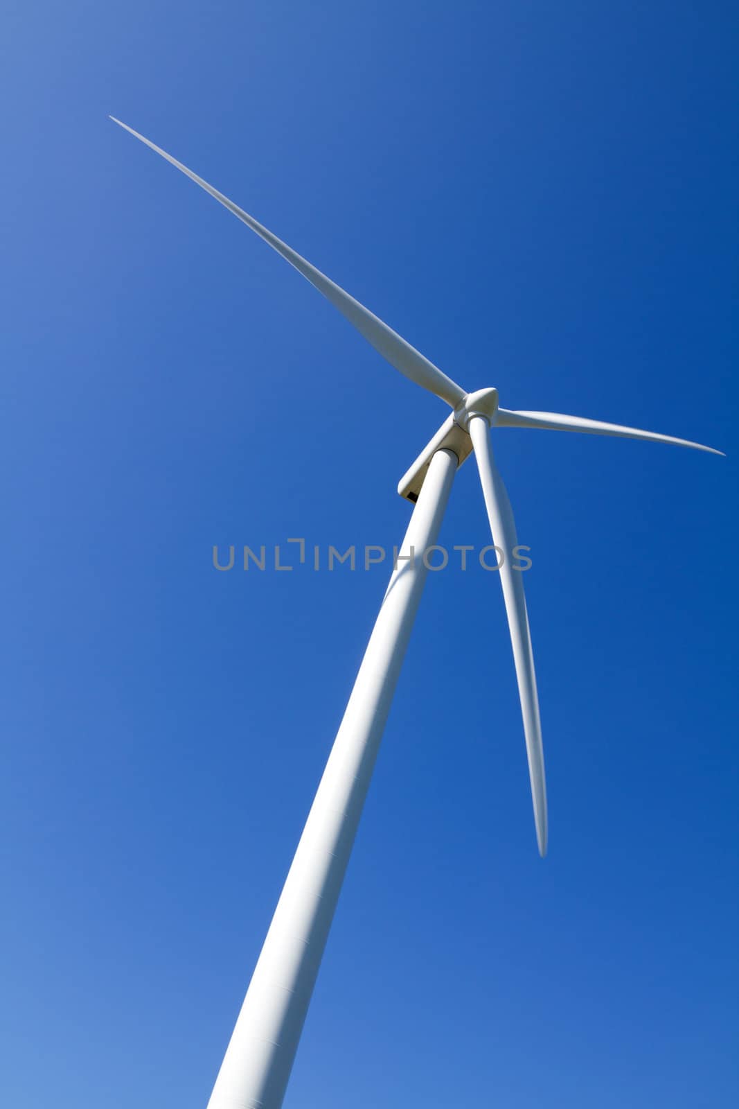 A wind turbine under clear blue sky