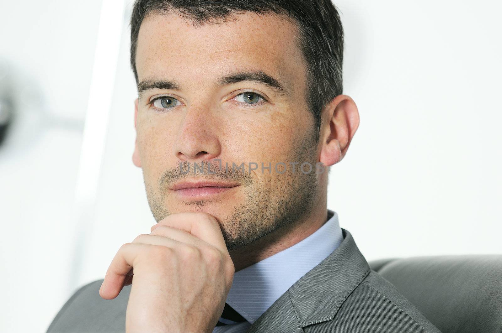 An attractive business man in a light business environment