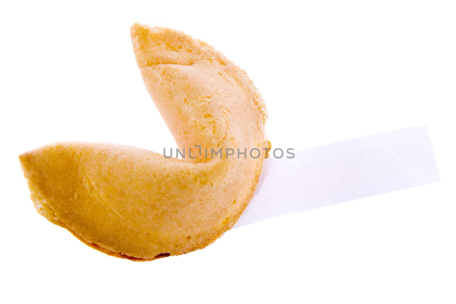 Isolated fortune cookie with a note.