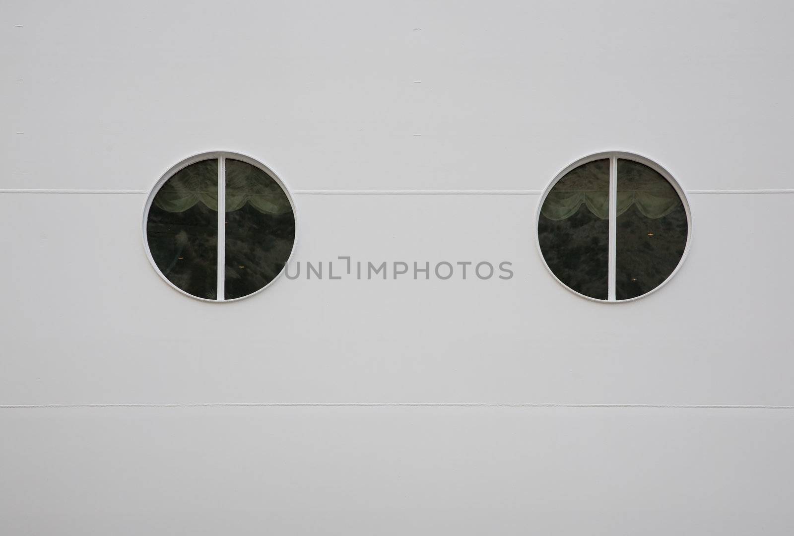 Two portholes in huge white cruiser. Space for text.