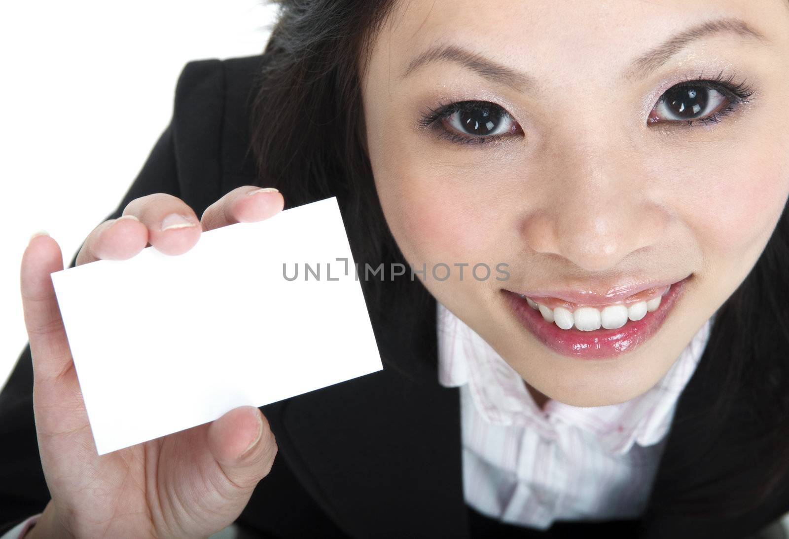 Asian businesswoman holding a blank business card and smiling at the camera