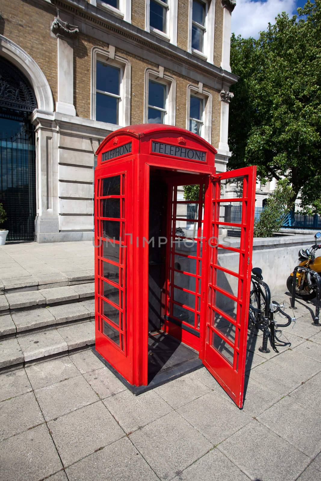 Old red telephone box in London by ints